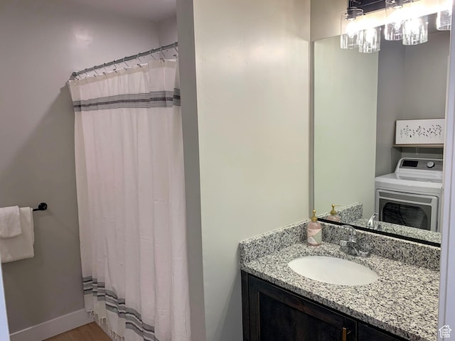 150 W Seasons Ln Unit 4, Garden City, UT 84028 - full bath featuring baseboards, washer / clothes dryer, vanity, and wood finished floors