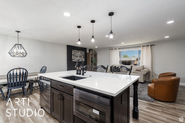 4351 W 1400 N, Plain City, UT 84404 - kitchen with a kitchen breakfast bar, a sink, light countertops, and light wood-style floors