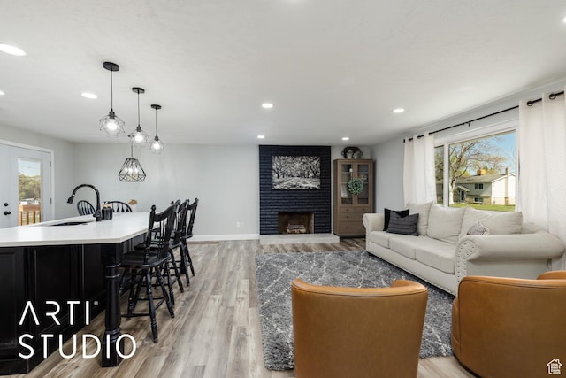 living room with light wood finished floors, recessed lighting, and a healthy amount of sunlight