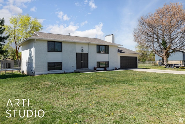 4351 W 1400 N, Plain City, UT 84404 - bi-level home featuring a chimney, concrete driveway, brick siding, a trampoline, and an attached garage