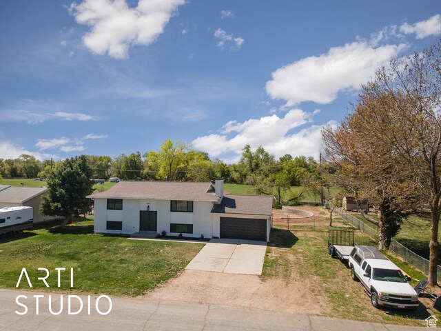 4351 W 1400 N, Plain City, UT 84404 - bi-level home with a chimney, stucco siding, concrete driveway, a front yard, and a garage