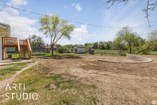 4351 W 1400 N, Plain City, UT 84404 - view of yard featuring a shed, a playground, a trampoline, a deck, and stairs