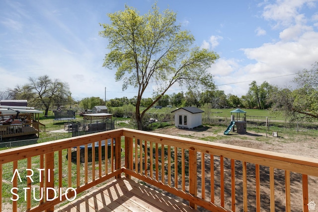 4351 W 1400 N, Plain City, UT 84404 - deck featuring a playground, a shed, an outdoor structure, a lawn, and a trampoline