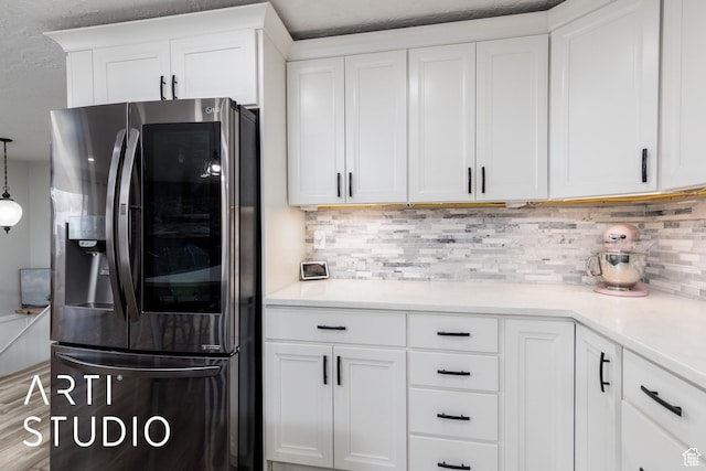4351 W 1400 N, Plain City, UT 84404 - kitchen with light countertops, stainless steel fridge, decorative backsplash, and white cabinetry