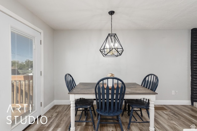 4351 W 1400 N, Plain City, UT 84404 - dining space featuring a chandelier, wood finished floors, and baseboards