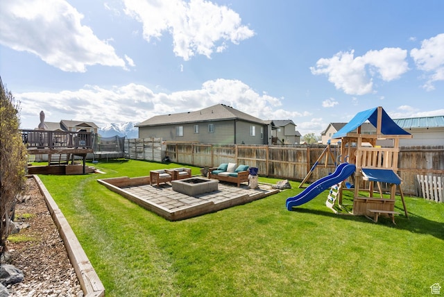 view of play area with a yard, a fenced backyard, a residential view, and a deck
