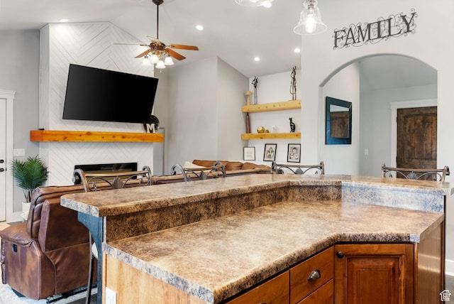 kitchen with arched walkways, open floor plan, vaulted ceiling, recessed lighting, and a ceiling fan