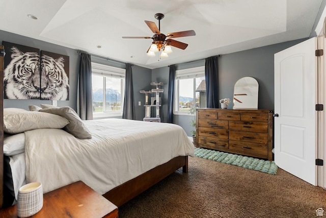 bedroom with carpet floors, ceiling fan, and multiple windows