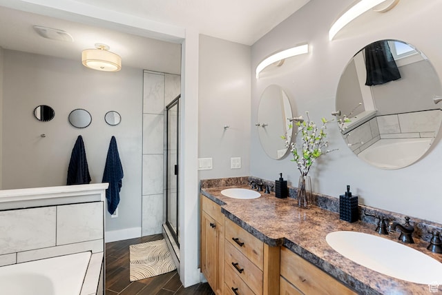 bathroom featuring wood finished floors, a sink, and a stall shower