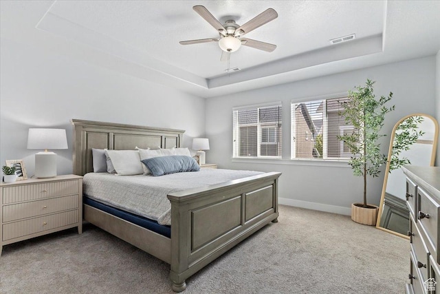 4941 W Chrome Rd, Herriman, UT 84096 - bedroom featuring a tray ceiling, visible vents, baseboards, light colored carpet, and ceiling fan
