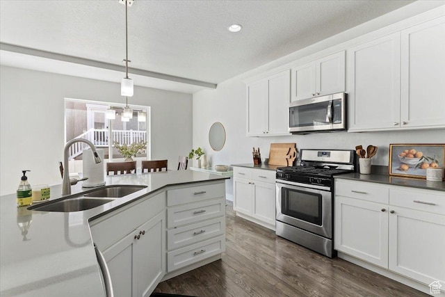4941 W Chrome Rd, Herriman, UT 84096 - kitchen with a sink, hanging light fixtures, an inviting chandelier, white cabinetry, and appliances with stainless steel finishes