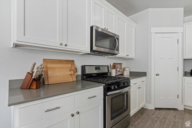 4941 W Chrome Rd, Herriman, UT 84096 - kitchen with white cabinets, stainless steel appliances, and wood finished floors
