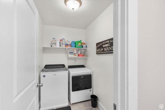clothes washing area featuring light tile patterned floors, laundry area, and independent washer and dryer