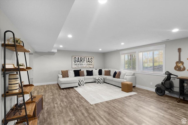 living room with recessed lighting, wood finished floors, and baseboards