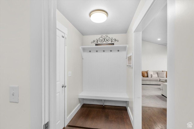 mudroom with wood finished floors and baseboards