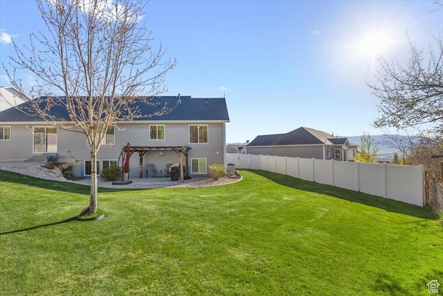 rear view of property with a pergola, central air condition unit, fence, a yard, and a patio