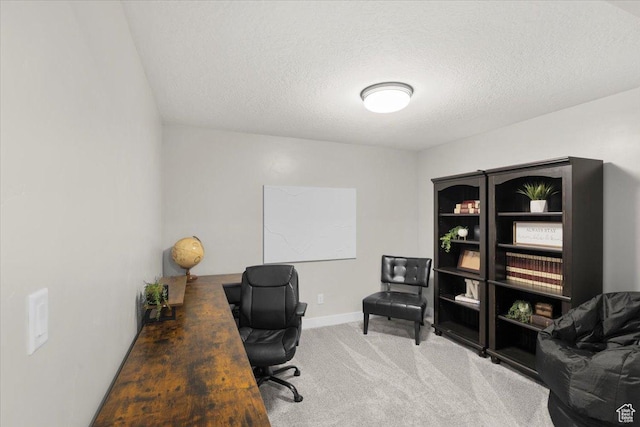 carpeted office space with baseboards and a textured ceiling