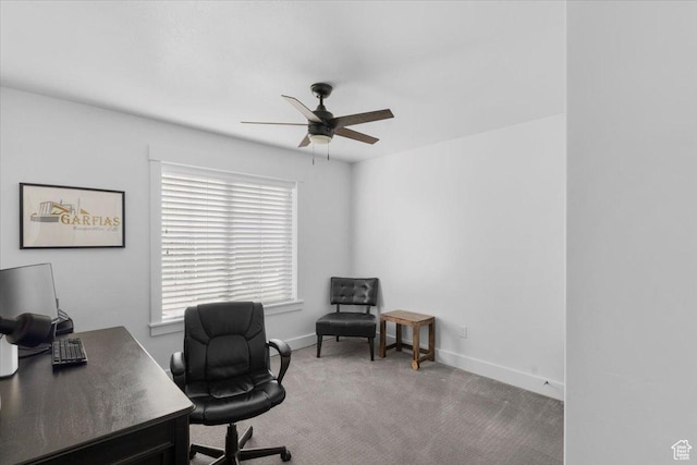 office area featuring baseboards, a ceiling fan, and carpet