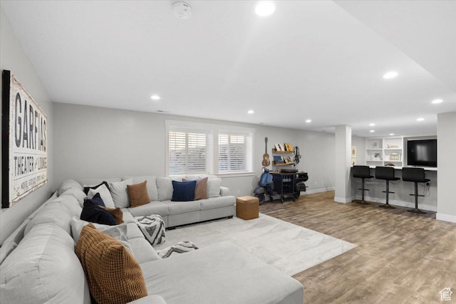 living room featuring recessed lighting, light wood finished floors, and baseboards