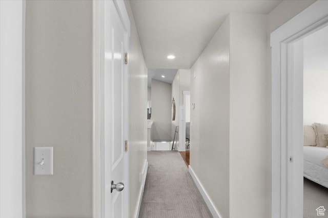 hall featuring recessed lighting, baseboards, and carpet