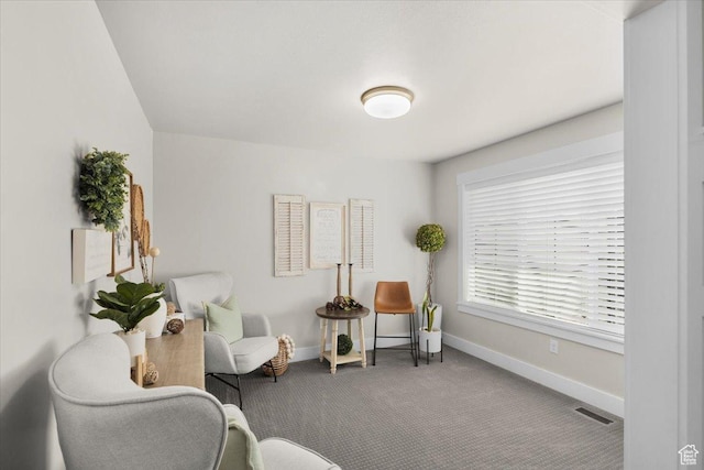 sitting room with carpet, visible vents, and baseboards