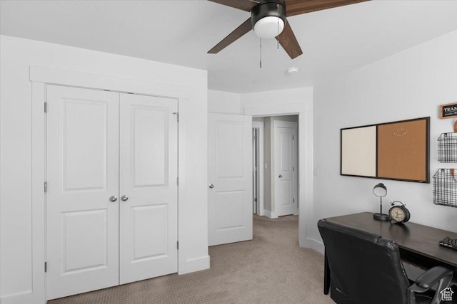 office area featuring baseboards, light colored carpet, and ceiling fan