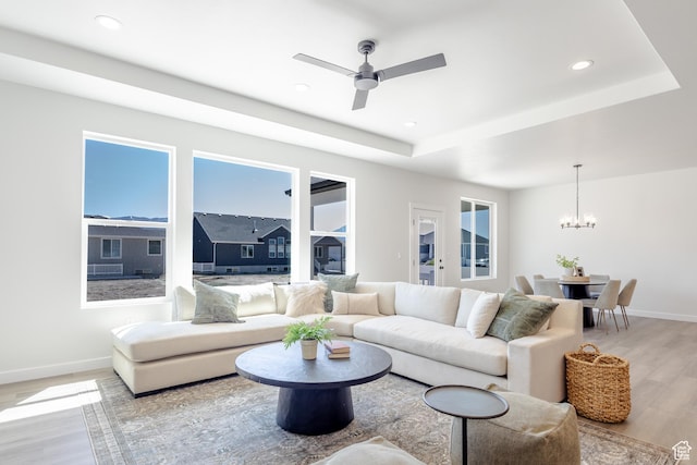3080 N 2875 W Unit 25, Plain City, UT 84404 - living room featuring light wood-type flooring, baseboards, a chandelier, a raised ceiling, and recessed lighting