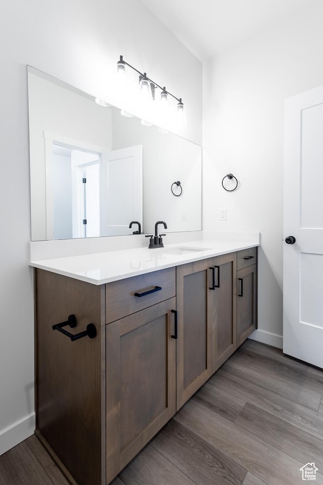 3080 N 2875 W Unit 25, Plain City, UT 84404 - bathroom featuring baseboards, wood finished floors, and vanity