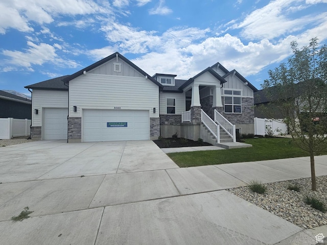 3080 N 2875 W Unit 25, Plain City, UT 84404 - craftsman-style house featuring board and batten siding, stone siding, a garage, and driveway