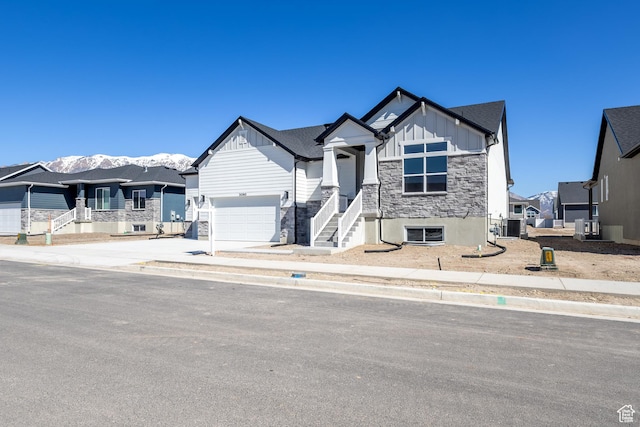 3080 N 2875 W Unit 25, Plain City, UT 84404 - view of front of home featuring driveway, stone siding, board and batten siding, and a garage