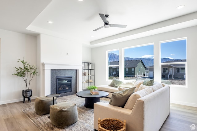 3080 N 2875 W Unit 25, Plain City, UT 84404 - living room featuring light wood-style floors, a fireplace, baseboards, recessed lighting, and a mountain view