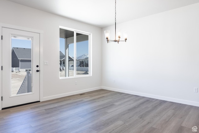 3080 N 2875 W Unit 25, Plain City, UT 84404 - unfurnished dining area featuring an inviting chandelier, wood finished floors, and baseboards