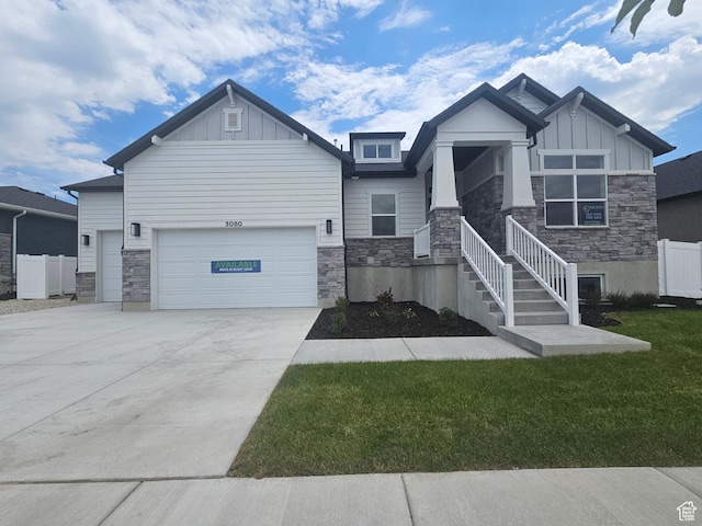 3080 N 2875 W Unit 25, Plain City, UT 84404 - craftsman inspired home with stone siding, board and batten siding, a garage, and driveway