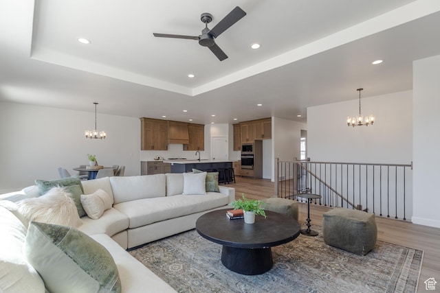 3080 N 2875 W Unit 25, Plain City, UT 84404 - living area with a chandelier, ceiling fan, light wood-style flooring, recessed lighting, and a raised ceiling