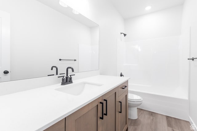 3080 N 2875 W Unit 25, Plain City, UT 84404 - bathroom featuring toilet, recessed lighting, wood finished floors, washtub / shower combination, and vanity