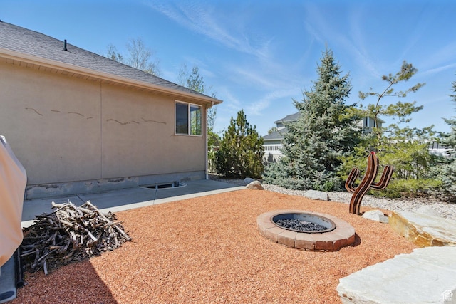 view of yard featuring a fire pit and a patio area