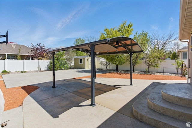 view of patio / terrace featuring a fenced backyard, an outbuilding, and a storage shed