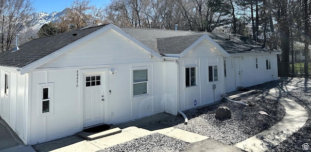 view of front facade featuring roof with shingles and board and batten siding