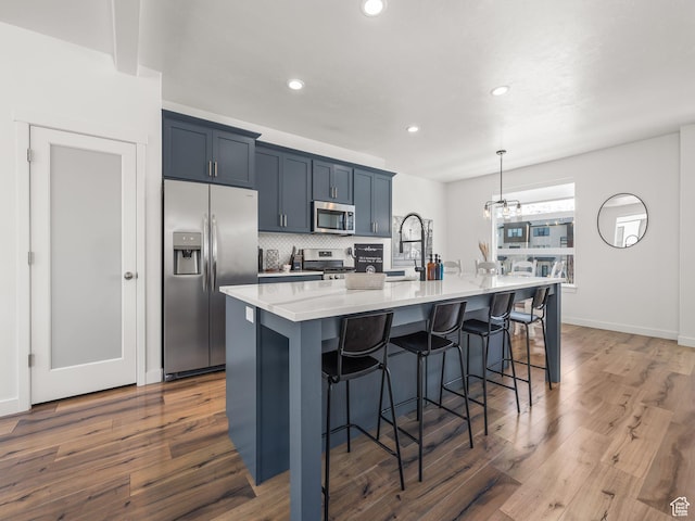 452 S Wood Stream Rd, American Fork, UT 84003 - kitchen featuring stainless steel appliances, a kitchen breakfast bar, wood finished floors, and recessed lighting