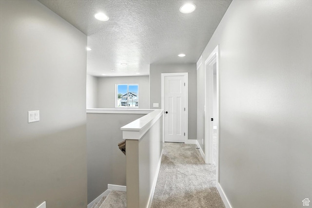 1273 S 240 W Lot 9, Tremonton, UT 84337 - hallway with an upstairs landing, a textured ceiling, recessed lighting, and light colored carpet