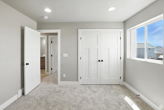 1273 S 240 W Lot 9, Tremonton, UT 84337 - unfurnished bedroom featuring light colored carpet, a closet, and recessed lighting