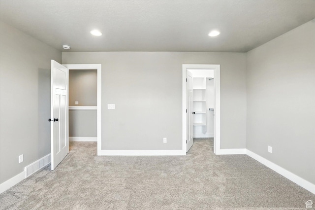 1273 S 240 W Lot 9, Tremonton, UT 84337 - unfurnished bedroom featuring carpet floors, a spacious closet, and recessed lighting