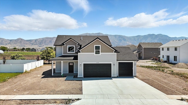 1273 S 240 W Lot 9, Tremonton, UT 84337 - view of front of home featuring a mountain view, concrete driveway, an attached garage, and a shingled roof