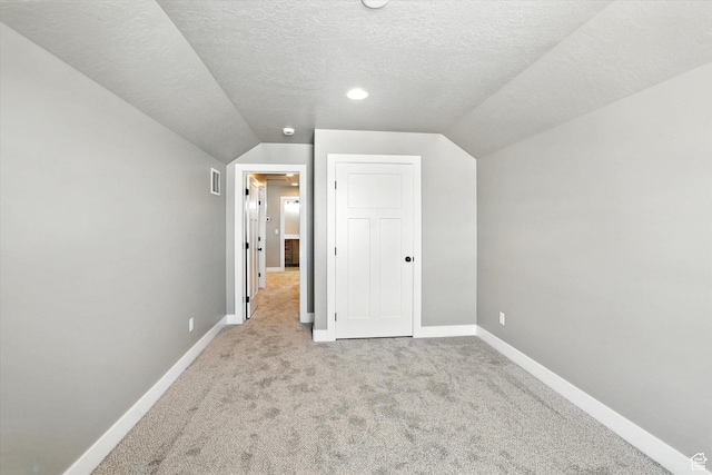 1273 S 240 W Lot 9, Tremonton, UT 84337 - unfurnished bedroom featuring carpet, vaulted ceiling, and a textured ceiling
