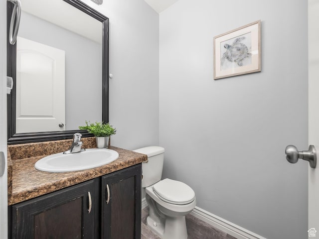 2046 N Belmont Dr, Saratoga Springs, UT 84045 - bathroom featuring toilet, vanity, wood finished floors, and baseboards