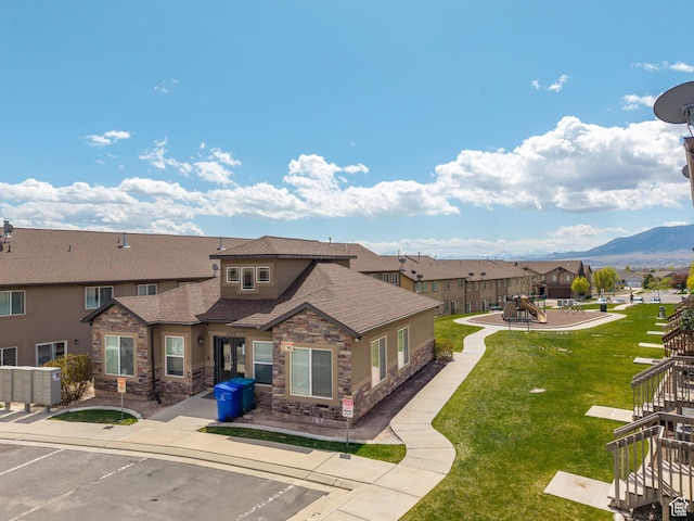 2046 N Belmont Dr, Saratoga Springs, UT 84045 - exterior space featuring stairway, a playground, a shingled roof, stone siding, and a lawn
