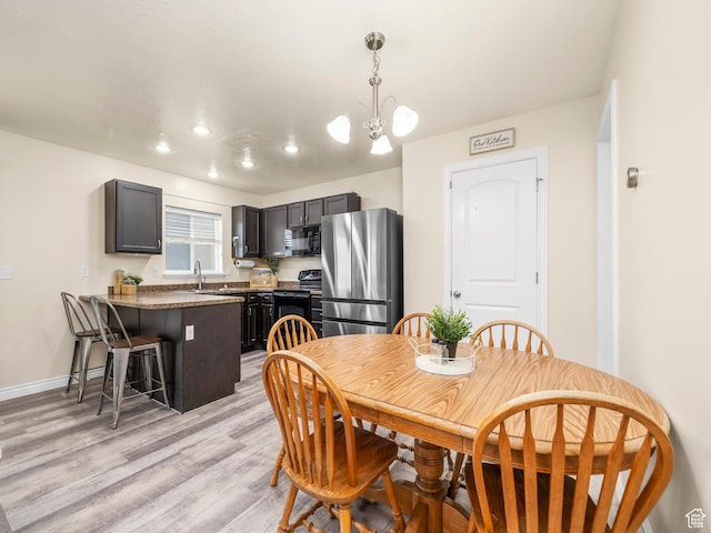 2046 N Belmont Dr, Saratoga Springs, UT 84045 - dining area with baseboards, recessed lighting, an inviting chandelier, and light wood-style flooring