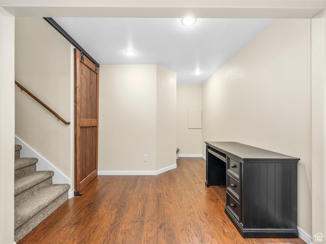 2046 N Belmont Dr, Saratoga Springs, UT 84045 - unfurnished office featuring a barn door, wood finished floors, and baseboards