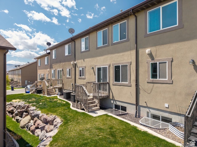 2046 N Belmont Dr, Saratoga Springs, UT 84045 - back of property featuring a wooden deck, a lawn, and stucco siding