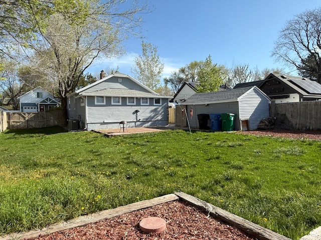 730 E 3155 S, Millcreek, UT 84106 - view of yard featuring a storage shed, an outbuilding, a fenced backyard, cooling unit, and a patio area